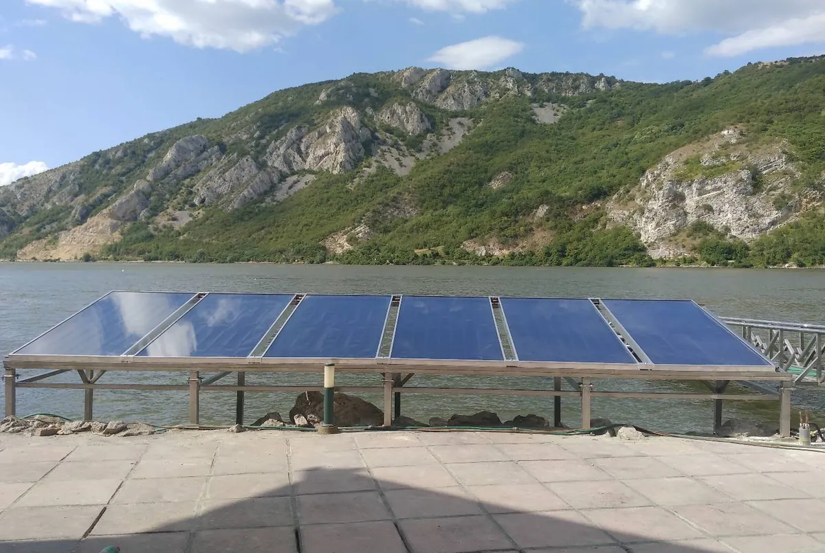 ELSOL solar collectors on a mounting frame by the river