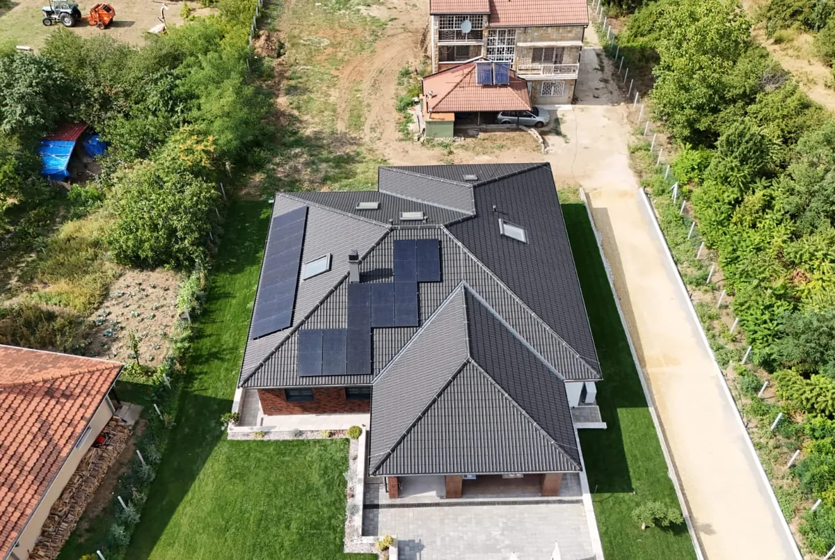 Solar panels on the roof of a family house, aerial view